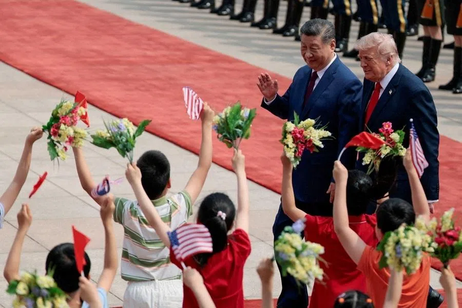 US President Donald Trump walks with Chinese President Xi Jinping during a welcome ceremony at the Great Hall of the People, in Beijing, China, on 14 May 2026.