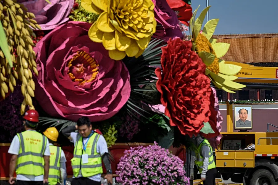 Workers set up an installation for the 1 October National Day celebrations in front of a portrait of late Communist leader Mao Zedong at Tiananmen Square in Beijing, China, on 21 September 2023. (Jade Gao/AFP)
