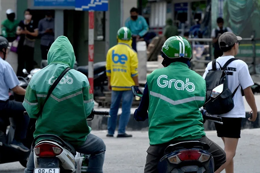 Ride-hailing drivers wait for passengers at the entrance of a bus station in Hanoi, on 11 September 2026.