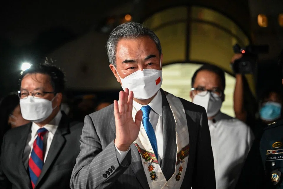 Chinese Foreign Minister Wang Yi gestures upon arriving for an official visit to the Philippines, at Villamor Airbase in Pasay, Metro Manila, on 5 July 2022. (Jam Sta Rosa/AFP)