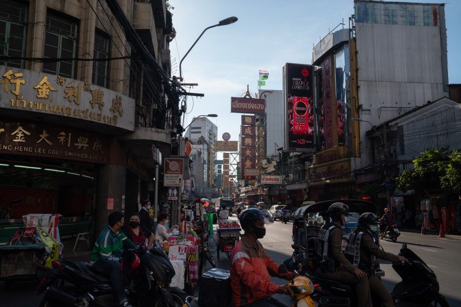 Motorcyclists wait an a junction on Yaowarath road in the Chinatown district of Bangkok, Thailand on 14 May 2021. (Nicolas Axelrod/Bloomberg)