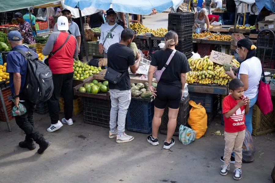 People buy food at the Coche wholesale market, in Caracas, Venezuela, on 20 January 2026. (Marco Bello/Reuters)