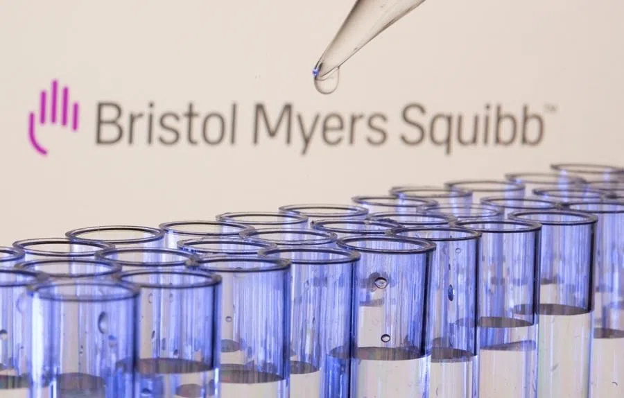 Test tubes are seen in front of a displayed Bristol Myers Squibb logo in this illustration taken on 21 May 2021.