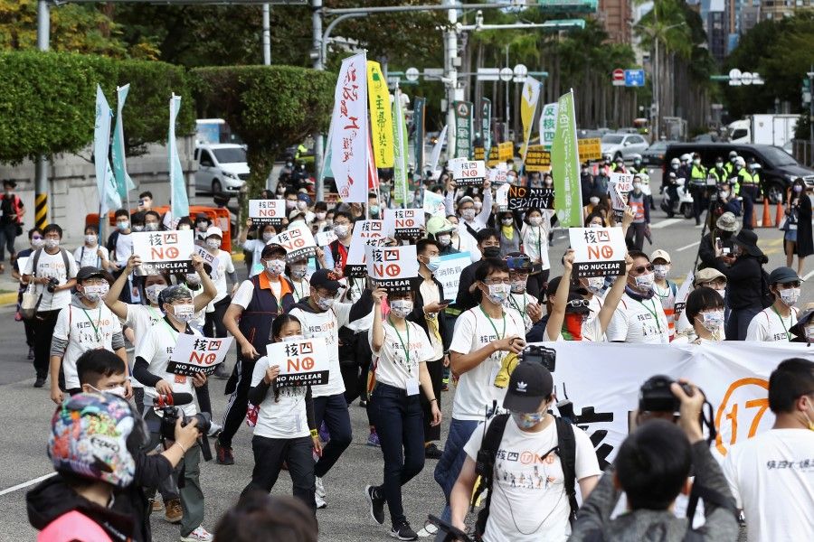 Demonstrators take part in a march against nuclear power ahead of a referendum on whether the government should continue building the stalled Fourth Nuclear Power Plant, in Taipei, Taiwan, 5 December 2021. (Annabelle Chih/Reuters)