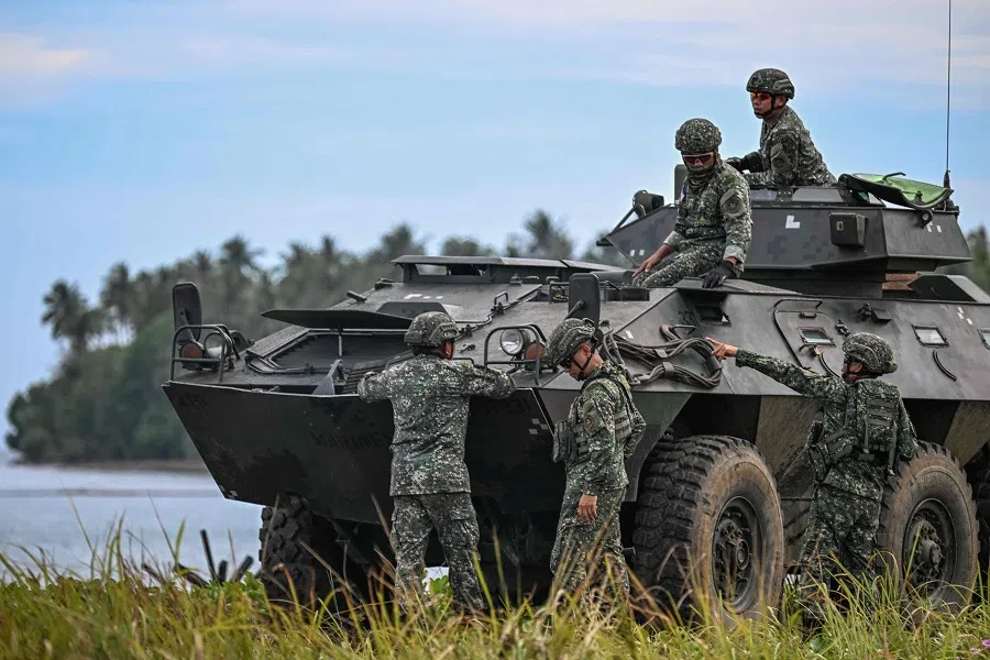 Philippine military servicemen are seen by an armoured personnel carrier as they take part in a counter-landing live fire exercise during the annual US-Philippines joint military “Balikatan” exercise in Rizal, Palawan, Philippines, on 28 April 2025.