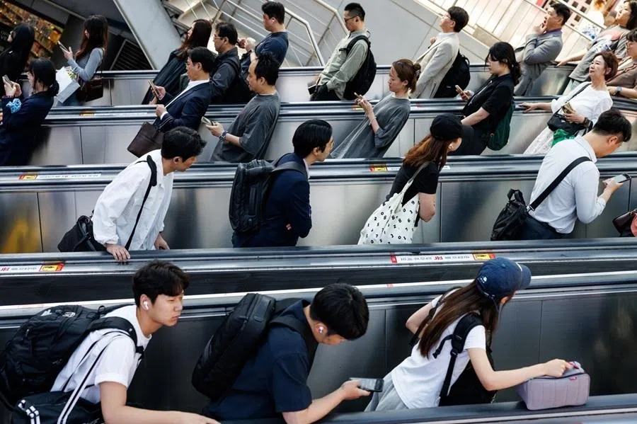 Morning commuters ride escalators outside Seoul Station in Seoul, South Korea, on 18 May 2026.