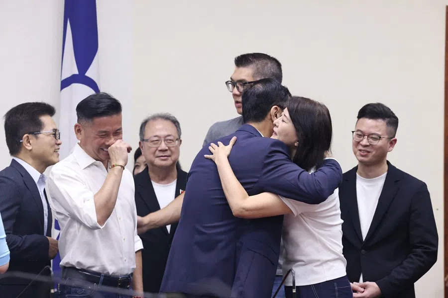 Lawmakers of Taiwan’s main opposition Kuomintang (KMT) party hug each other after the recall election in Taipei on 26 July 2025. (I-Hwa Cheng/AFP)