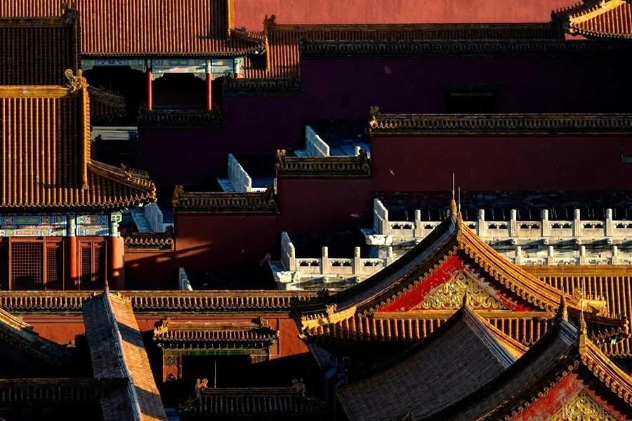 Birds fly beside the traditional rooftops of the Forbidden City during sunset time in Beijing, China, on 7 May 2026.