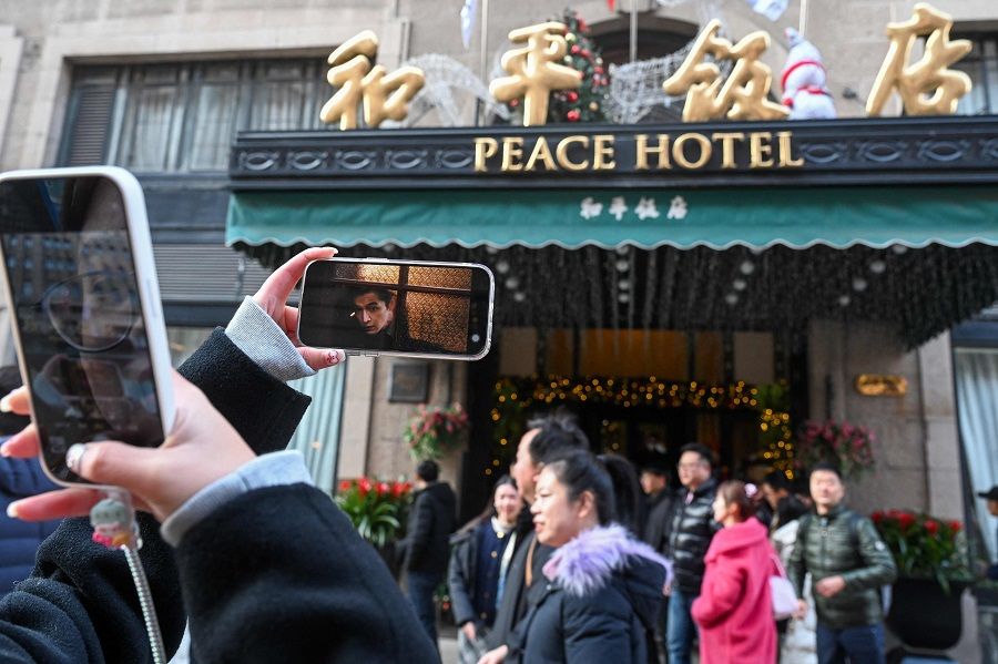 The photo taken on 7 January 2024 shows people visiting Peace Hotel, a historic location that features in the Chinese television series "Blossoms Shanghai" directed by Hong Kong director Wong Kar-wai, in Shanghai, China. (AFP)