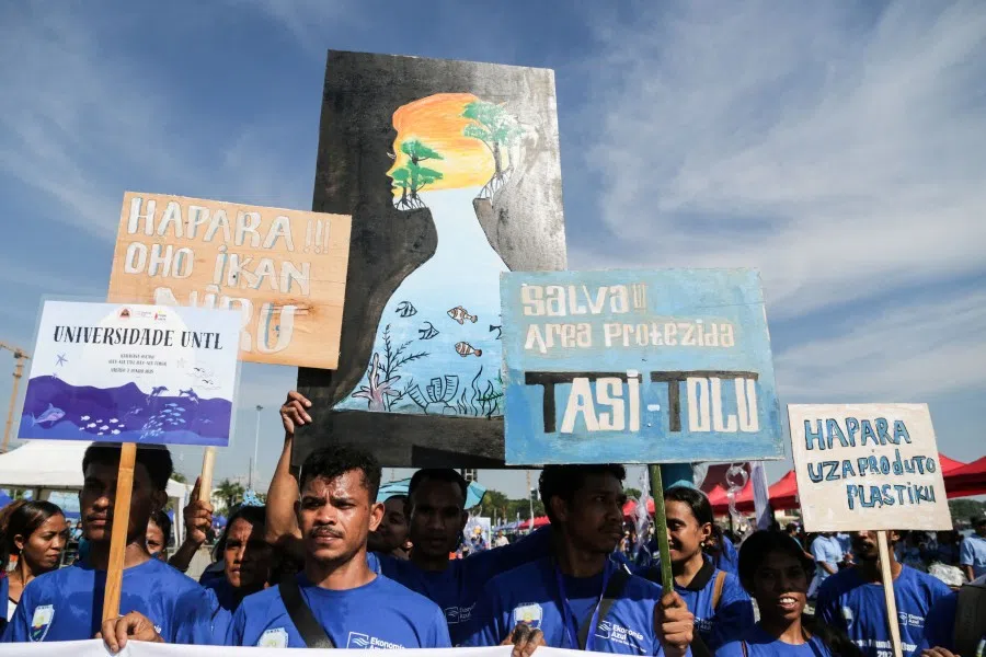 People march with placards calling for the protection of the oceans in Dili on 7 June 2025, a day before World Oceans Day. (Valentino Dariell de Sousa/AFP)