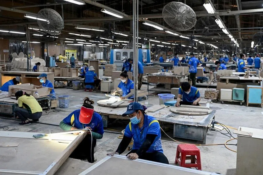 This photo taken on 4 November 2025 shows employees assembling furniture inside a factory in Ho Chi Minh City, Vietnam. (Nhac Nguyen/AFP)