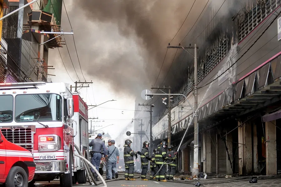 Firefighters work to extinguish a fire at a shopping mall in Sao Paulo, Brazil, on 30 October 2024. (Carla Carniel/Reuters)