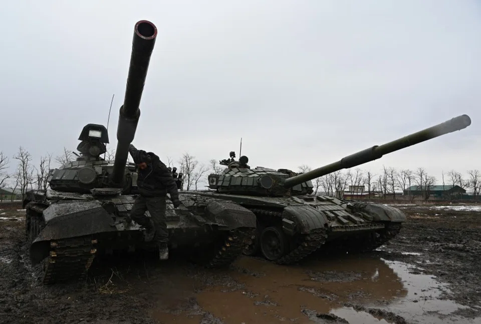 A Russian service member jumps off a T-72B3 main battle tank during drills held by the armed forces of the Southern Military District at the Kadamovsky range in the Rostov region, Russia, 3 February 2022. (Sergey Pivovarov/Reuters)