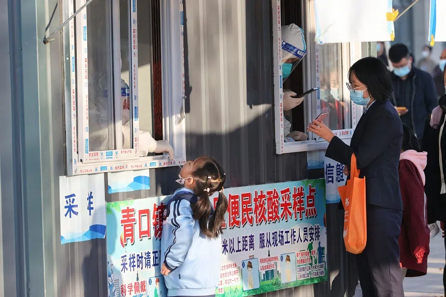 This photo taken on 19 October 2022 shows a child undergoing a nucleic acid test for the Covid-19 coronavirus in Lianyungang, Jiangsu province, China. (AFP)