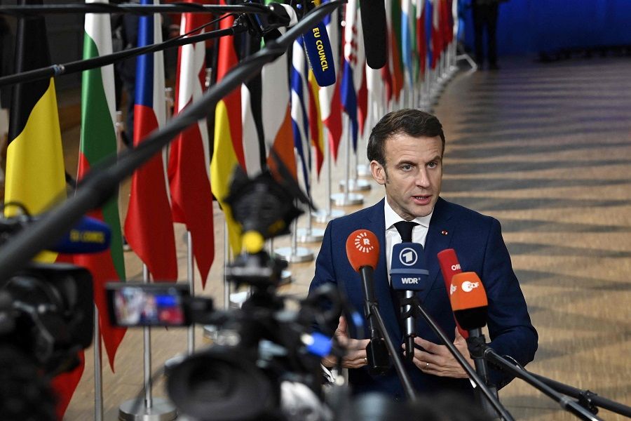 French President Emmanuel Macron answers journalists' questions as he arrives to take part in a European Council Summit in Brussels, Belgium, on 15 December 2022. (John Thys/AFP)