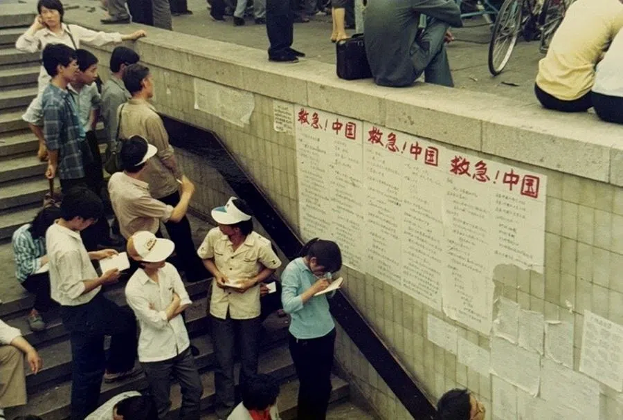 Walls of an underpass along Chang’an Avenue covered with handwritten posters.