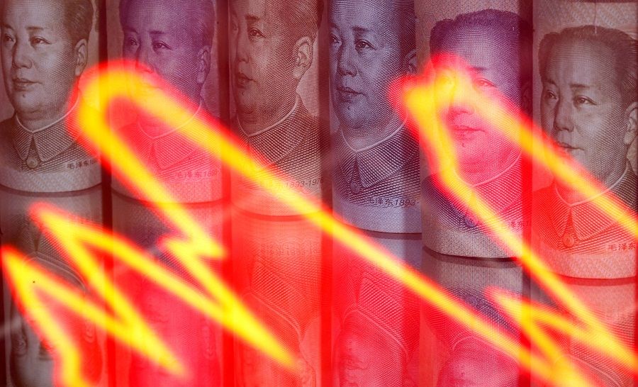 Chinese RMB banknotes are seen behind an illuminated stock graph in this illustration taken on 10 February 2020. (Dado Ruvic/Illustration/File Photo/Reuters)