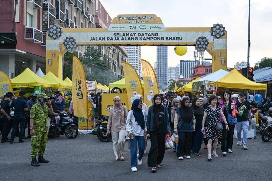 Muslim devotees buy food at a street market before breaking their fast during the Islamic holy fasting month of Ramadan in the Kampung Baru neighbourhood of Kuala Lumpur, Malaysia, on 18 March 2024. (Mohd Rasfan/AFP)