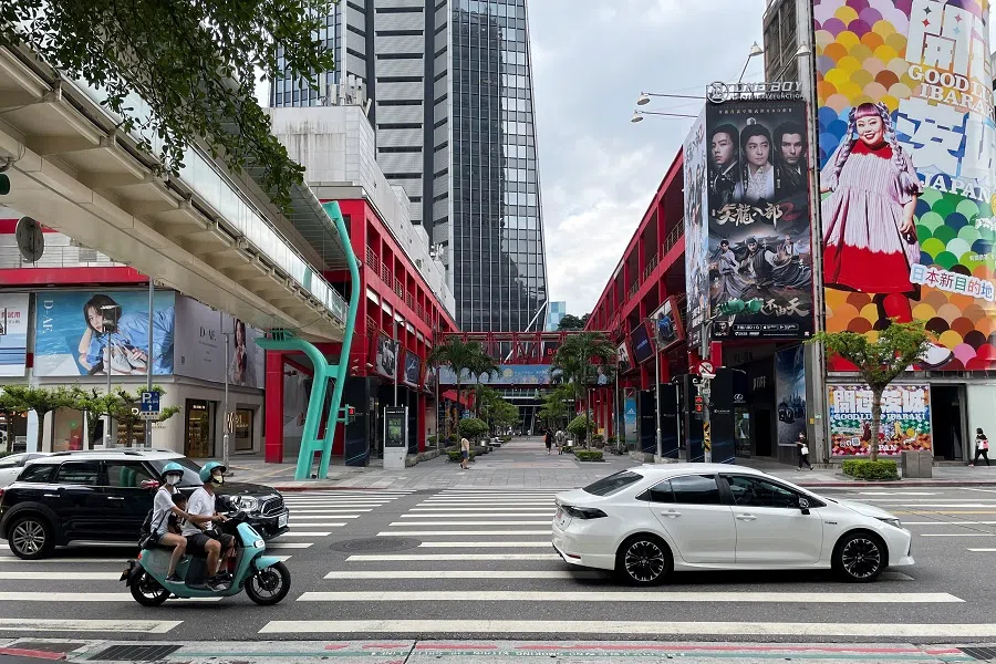 People ride a scooter on a street in Taipei, Taiwan, 10 August 2022. (Aleksander Solum/Reuters)