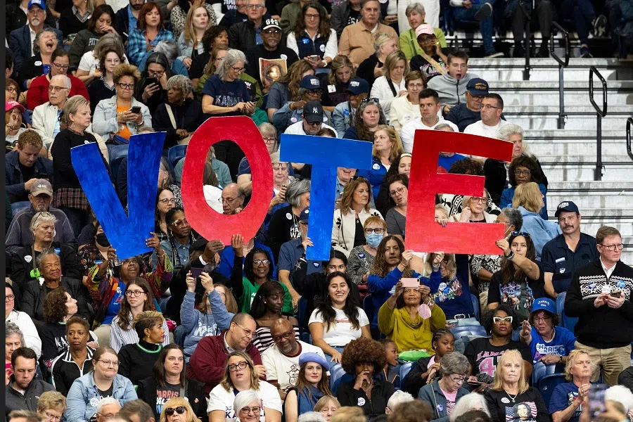 Supporters hold signs as former US President Barack Obama speaks during a campaigning event for US Vice President and Democratic presidential candidate Kamala Harris in Pittsburgh, Pennsylvania on 10 October 2024. (Ryan Collerd/AFP)