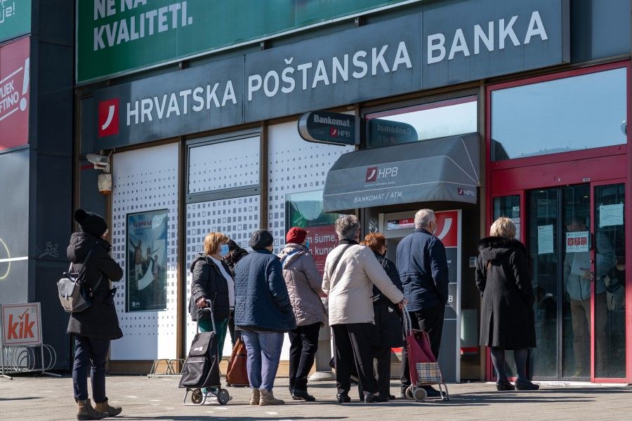 Elderly customers queue for their pensions outside a Hrvatska Postanska Banka dd (HPB) branch in Zagreb, Croatia, on 3 March 2022. HPB will acquire Sberbank of Russia PJSC's business in Croatia as Europe carves up the bank's business in the region following sanctions sparked by President Vladimir Putin's invasion of Ukraine prompted a run on its local deposits. (Peter Santini/Bloomberg)