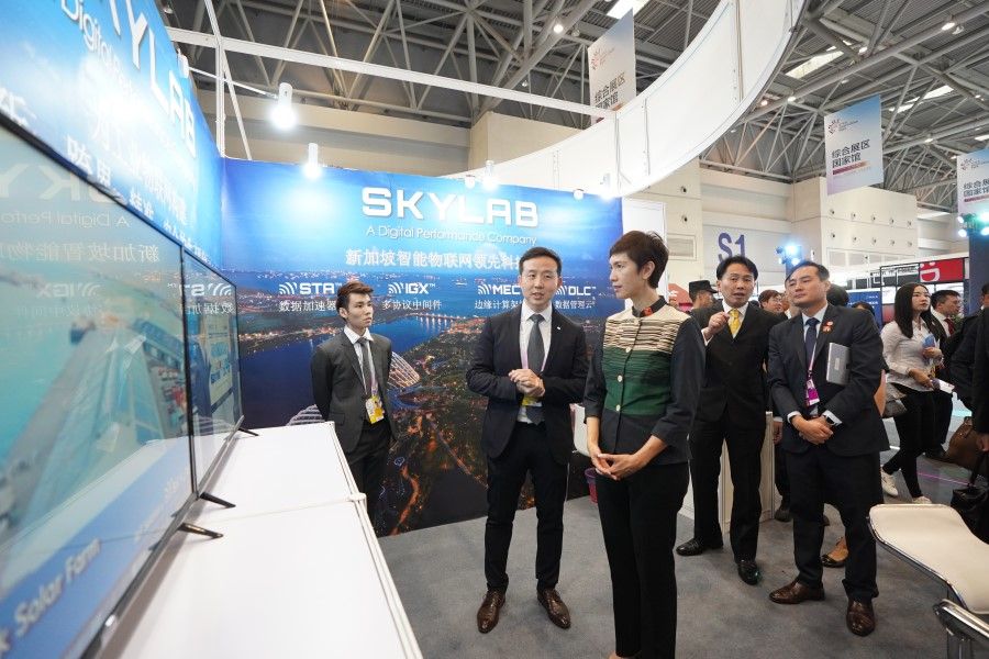 Singapore Manpower Minister Josephine Teo (centre) and Mr Stephen Ho, managing director of SkyLab Services at the Singapore pavilion at the Smart China Expo 2019 in Chongqing. (IMDA)