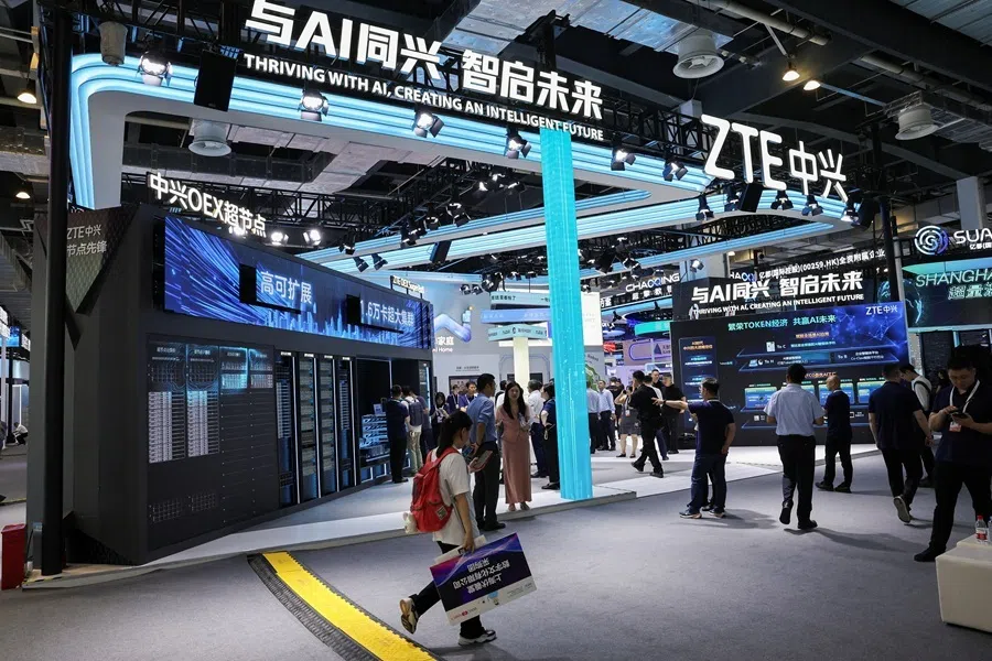 People walk past the ZTE booth during the World Artificial Intelligence Conference (WAIC) in Shanghai, China, on 17 July 2026.