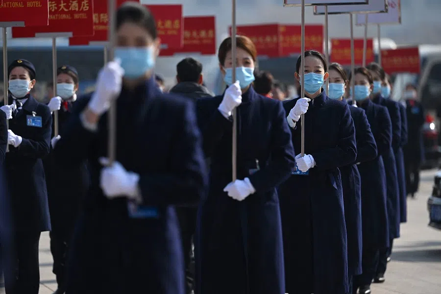 Hostesses wait for delegates after the second plenary session of the Chinese People's Political Consultative Conference (CPPCC) at the Great Hall of the People in Beijing on 7 March 2024. (Jade Gao/AFP)