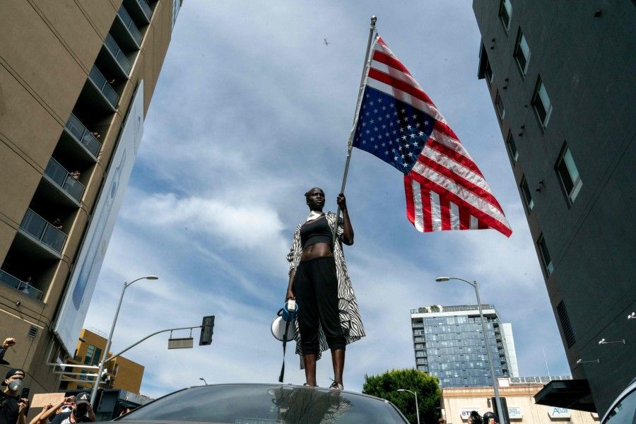 A protester takes a moment while speaking to the crowd as they march through Hollywood during a demonstration over the death of George Floyd while in Minneapolis Police custody, in Los Angeles, California, June 2, 2020. - Anti-racism protests have put several US cities under curfew to suppress rioting, following the death of George Floyd in police custody. (Kyle Grillot/AFP)