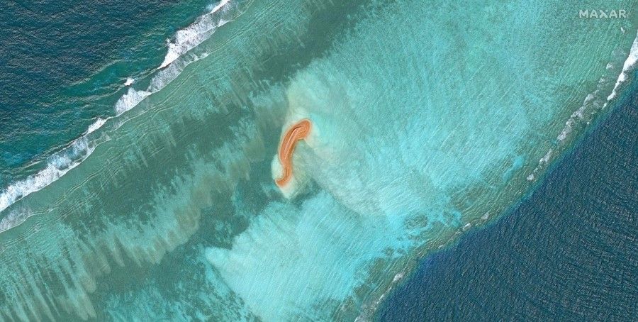 This handout satellite image taken on 4 November 2022 by Maxar Technologies shows a land formation (centre) at Eldad Reef in the Spratly Islands, in the disputed South China Sea. The Philippines said on 21 December 2022 it was "seriously concerned" over a report that China has started reclaiming several unoccupied land features in the disputed South China Sea. (Handout/Satellite image ©2022 Maxar Technologies/AFP)