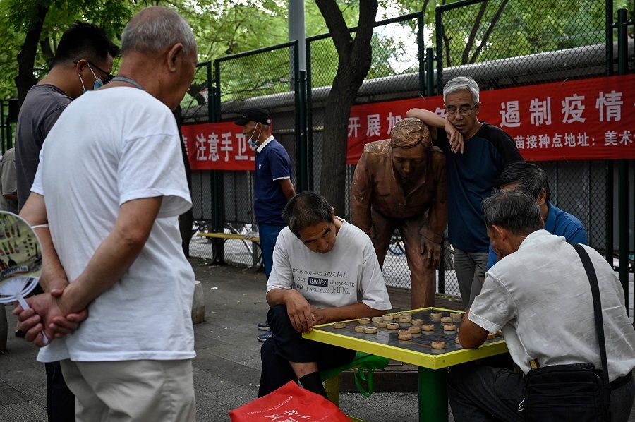 People play Chinese chess at a park in Beijing, China, on 23 August 2022. (Jade Gao/AFP)