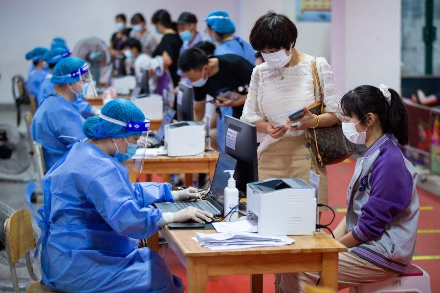 This photo taken on 21 August 2021 shows a high school student preparing to receive the Sinovac Covid-19 vaccine in Nanjing in China's eastern Jiangsu province. (STR/AFP)