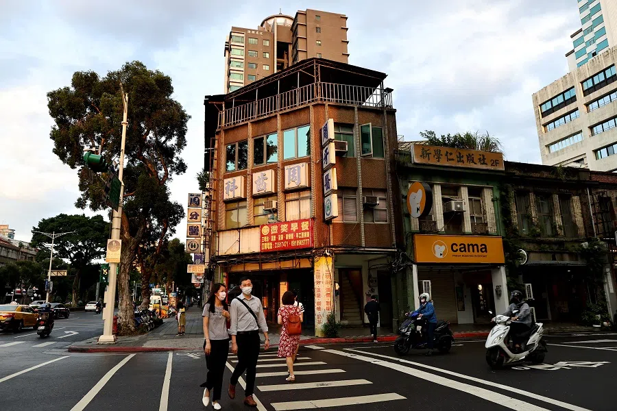 People walk on the streets during sunset hour in Taipei, Taiwan, 27 June 2022. (Ann Wang/Reuters)