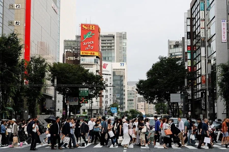 People walk at a shopping district in Tokyo, Japan, 16 June 2026.