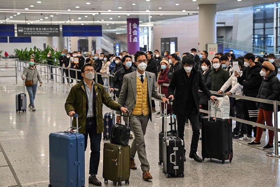 Passengers are seen upon their arrival at the Shanghai Pudong International Airport in Shanghai, China, on 8 January 2023. (Hector Retamal/AFP)