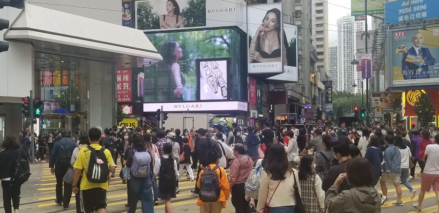 People walk on a street in Causeway Bay, Hong Kong, China, March 2023. (Photo: Tai Hing Shing)
