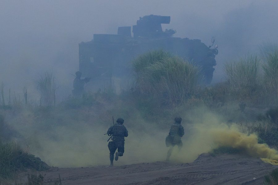 Taiwan soldiers run during the annual Han Kuang anti-landing drill in New Taipei City, Taiwan, on 27 July 2023. (Ann Wang/Reuters)
