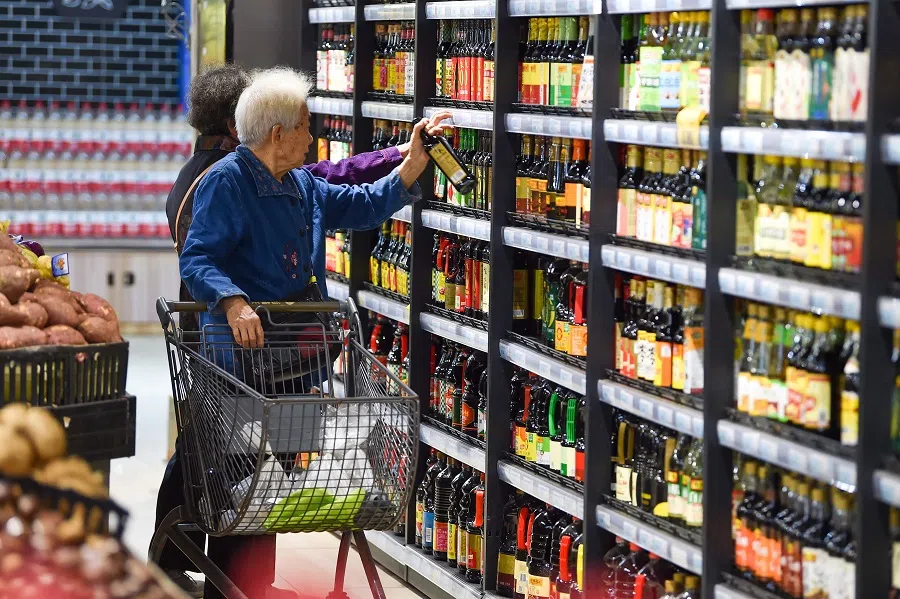 A customer shops at a supermarket in Nanjing, in China's eastern Jiangsu province on 13 October 2023. (AFP)