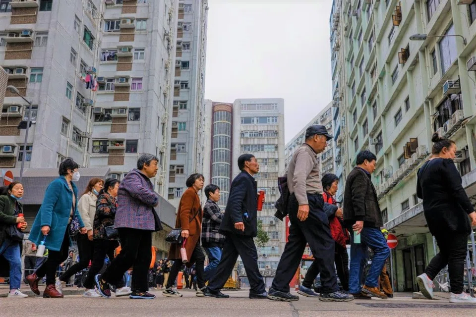 Mainland Chinese travellers on low-cost tours walk to a tourist bus after lunch at To Kwa Wan in Hong Kong, China, 30 March 2023. (Tyrone Siu/Reuters)