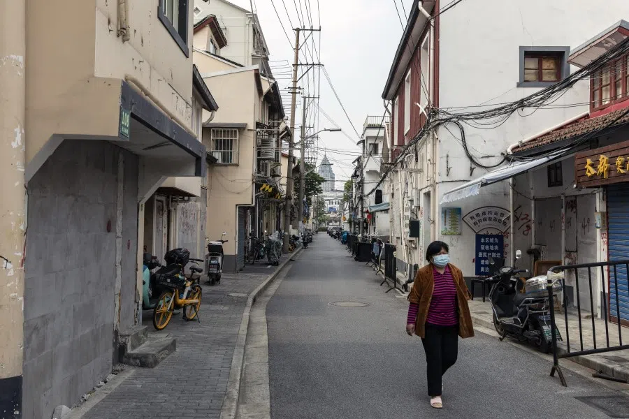 A resident walks along a near-empty road during a lockdown due to Covid-19 in Shanghai, China, on 16 May 2022. (Bloomberg)