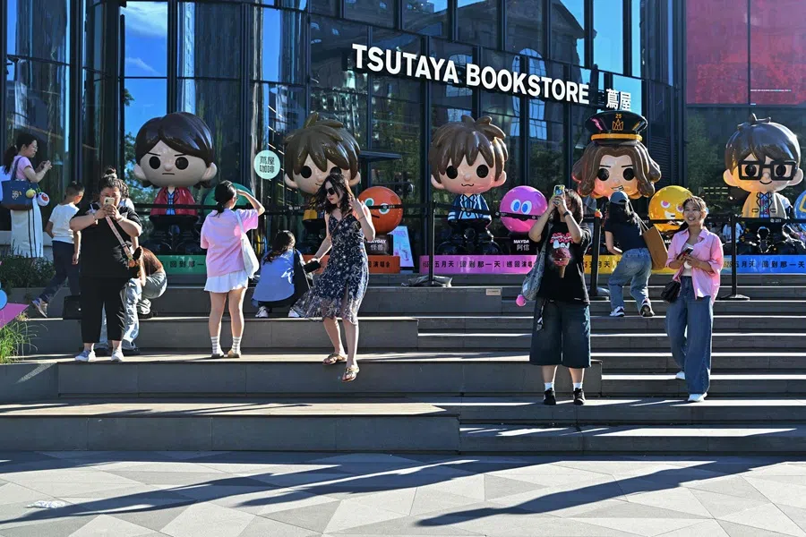 People visit shopping centres in Beijing on 2 June 2025. (Adek Berry/AFP)