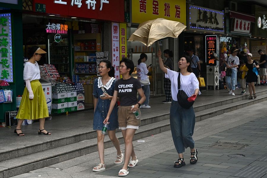 People are seen on a street at the Huangpu district in Shanghai, China, on 1 July 2023. (Pedro Pardo/AFP)