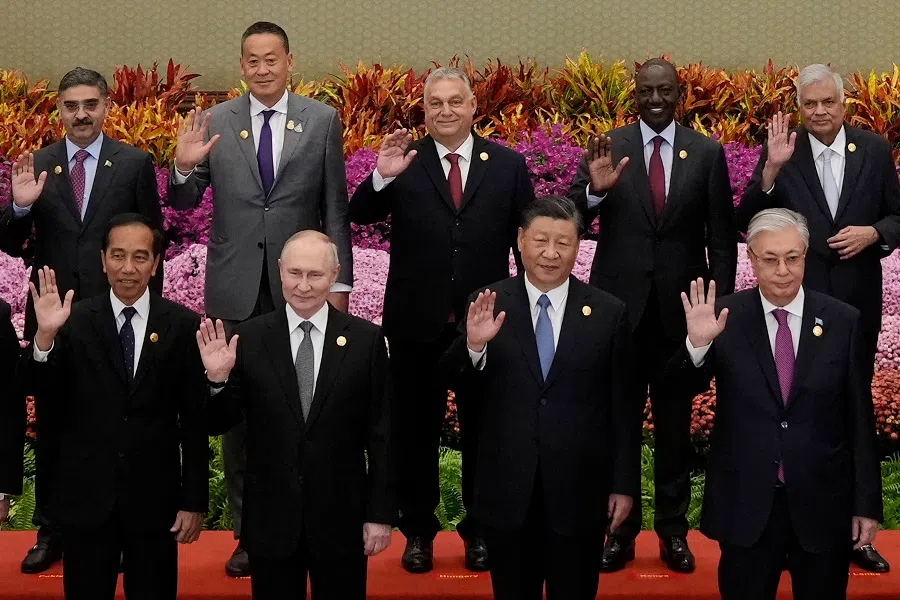 (front row, left to right) Indonesia's President Joko Widodo, Russia's President Vladimir Putin, China's President Xi Jinping, Kazakhstan's President Kassym-Jomart Tokayev with other leaders wave during a group photo at the third Belt and Road Forum for International Cooperation at the Great Hall of the People in Beijing on 18 October 2023. (Suo Takekuma/AFP)