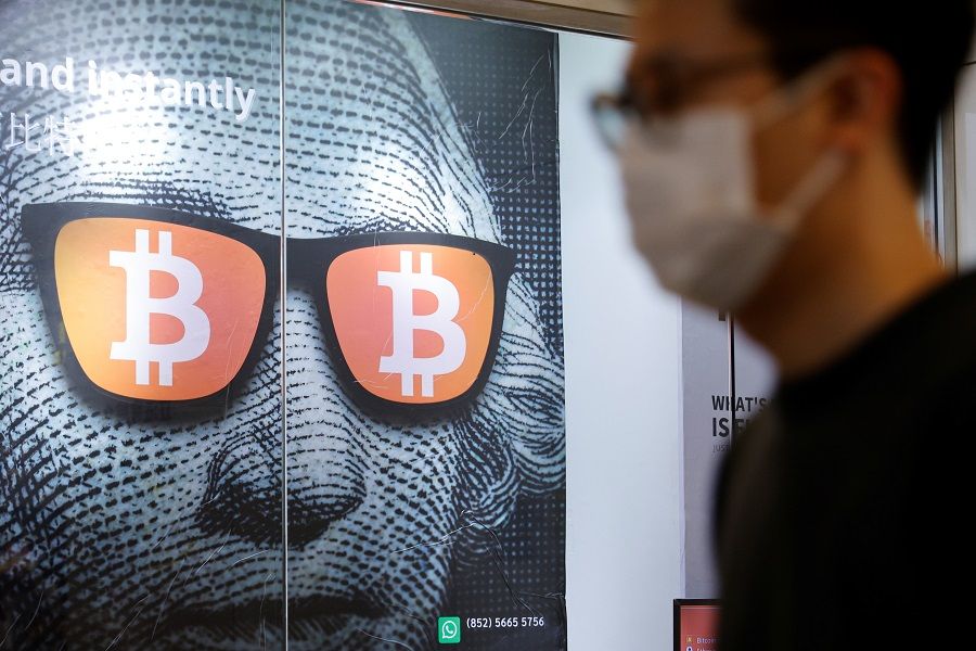 An advertisement for Bitcoin and cryptocurrencies is seen in Hong Kong, China, on 27 September 2021. (Tyrone Siu /Reuters)