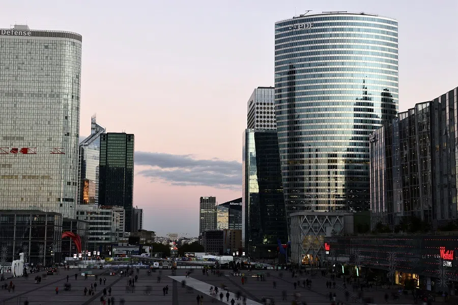 People walk through the financial and business district of La Defense in Puteaux near Paris, France, 23 October 2021. (Sarah Meyssonnier/Reuters)