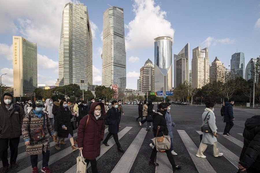 People cross the road in Pudong's Lujiazui Financial District in Shanghai, China, on 3 January 2023. (Qilai Shen/Bloomberg)