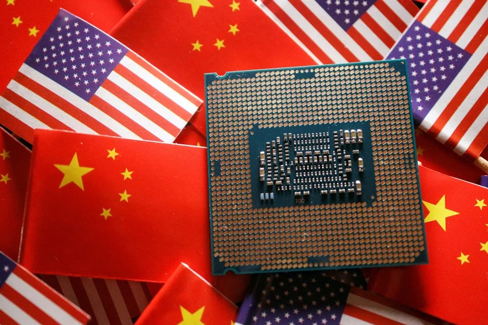 A central processing unit (CPU) semiconductor chip is displayed among flags of China and US, in this illustration picture taken 17 February 2023. (Florence Lo/Illustration/File Photo/Reuters)