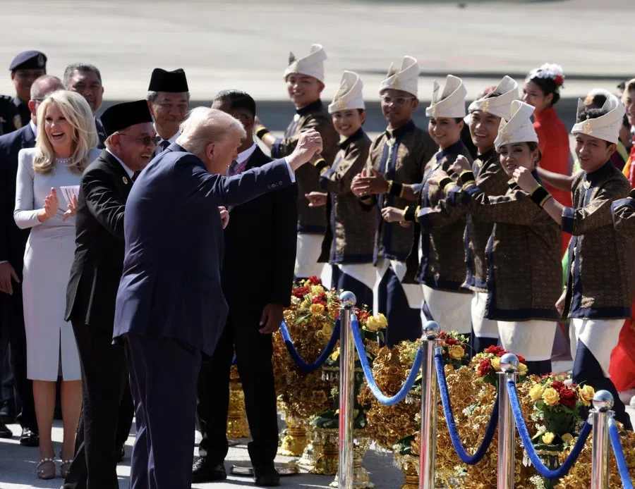 US President Donald Trump moves along with a lively troupe of traditional Malay dancers in vibrant costumes, as he arrives in Malaysia for the 47th ASEAN Summit, 26 October 2025.