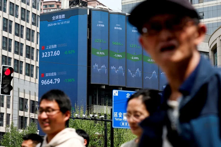 An electronic board shows Shanghai and Shenzhen stock indices in Shanghai, China, on 16 April 2025. (Go Nakamura/Reuters)