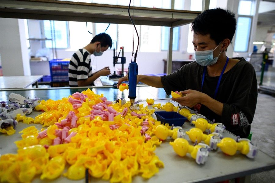 This photo taken on 20 May 2020 shows a worker assembling toys at the Mendiss toy factory in Shantou, Guangdong province, China. (Noel Celis/AFP)